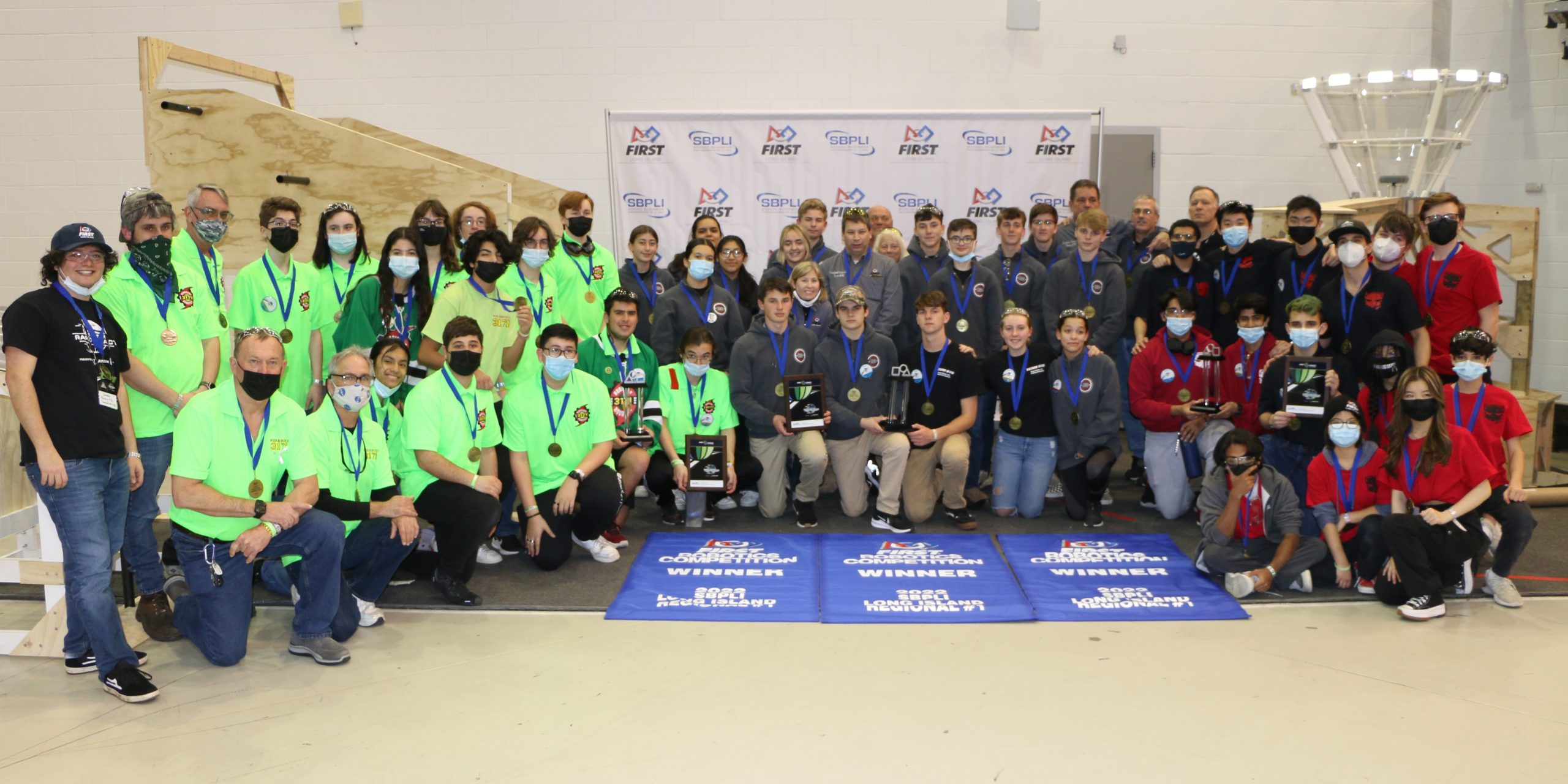 The winning alliance of (left to right) Team #3171 “HURRICANES” from Westhampton Beach High School, Team #870 “Team R.I.C.E.” from Southold Jr. Sr. High School and Team #2872 “CyberCats” from The Wheatley School display their championship banners during the 2022 SBPLI Long Island Regional #1.