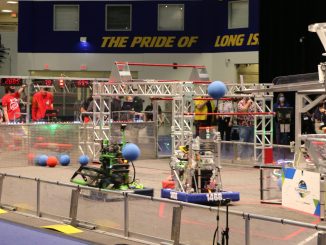 Blue Alliance robots from Team #1796 “RoboTigers” from Queens Technical High School and Team #1496 “Hicksville J-Birds” from Hicksville High School attempt to score their cargo into the hub during the finals of the 2022 SBPLI Long Island Regional #2.