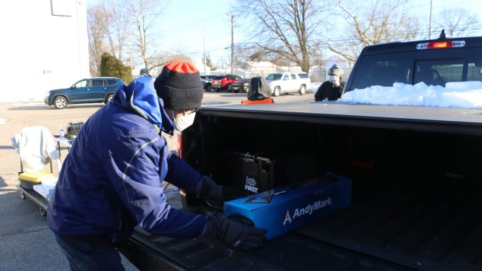 School-Business Partnerships of Long Island, Inc. (SBPLI) DBA Long Island FIRST volunteers distribute kits of parts to local team leaders as part of the FIRST Robotics Competition season kickoff at SCHENCK USA CORP. in Deer Park on January 8.