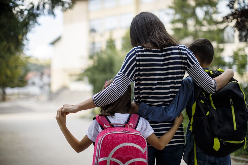 Mother taking kids to school