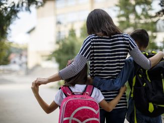 Mother taking kids to school