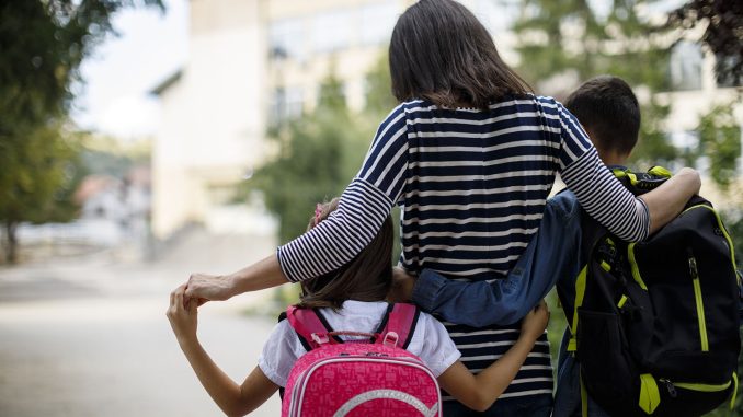 Mother taking kids to school