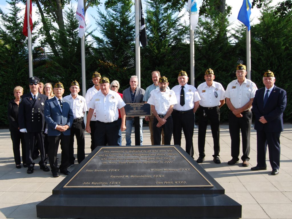 Allan M. Dorman (right) is joined by members of the Col. Francis S. Midura Veterans of Foreign Wars Post #12144, village board members, employees and residents at the Sepetmber 11 memorial ceremony. The village remembered five local first responders who died during the 9/11 attacks.