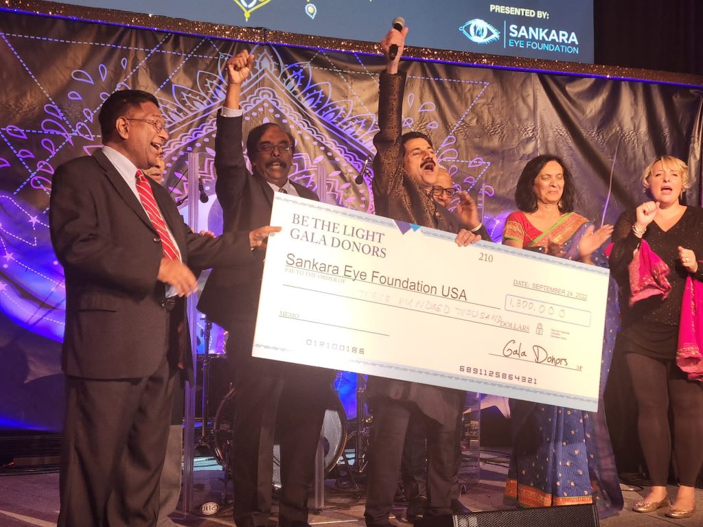 Gala Co-Chair Mohan Wanchoo (center) holds up a check for the Sankara Eye Foundation (SEF) in the amount of $1.3 million during the Be The Light Gala, which took place at Cipriani 42nd Street in Manhattan on September 24, 2022. Also pictured (left to right): SEF USA Co-Founder/Executive Chairman Murali Krishnamurthy, Co-Founder/President K. Sridharan, Board Member Anju Desai, and Fundraiser Erin Ward. (Behind Mr. Wanchoo: SEF USA Board Member R. Sundar.)