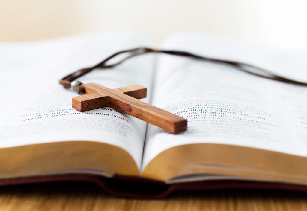 Bible and cross on desk