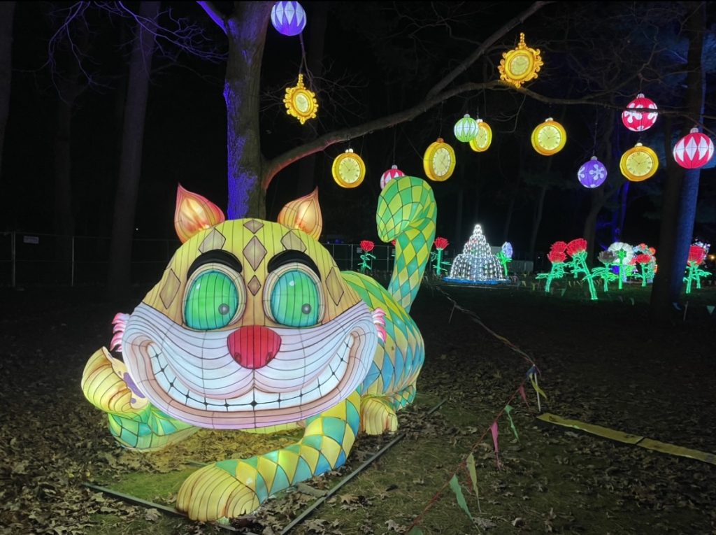 Lit up structure of the Alice in Wonderland Cheshire Cat at the LuminoCity Festival taken by Kelly Alvarado