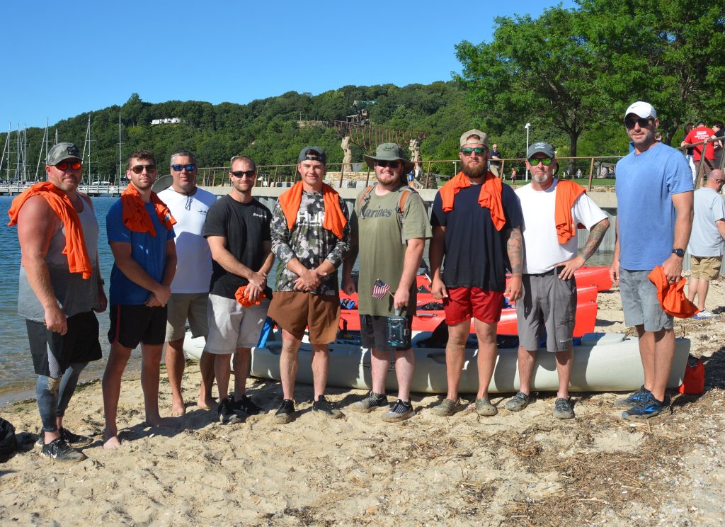 Pictured (l-r): PSEG Long Island employee-military veterans Thomas Leuschner, Evan Rohman, Richard Rohman, Matthew Testagrose, Michael Probst, Devin McLaughlin, Michael Pira, Leo Tolson and Thomas Sketch after a 22-mile kayaking trip to increase awareness about PTSD and veteran suicide.