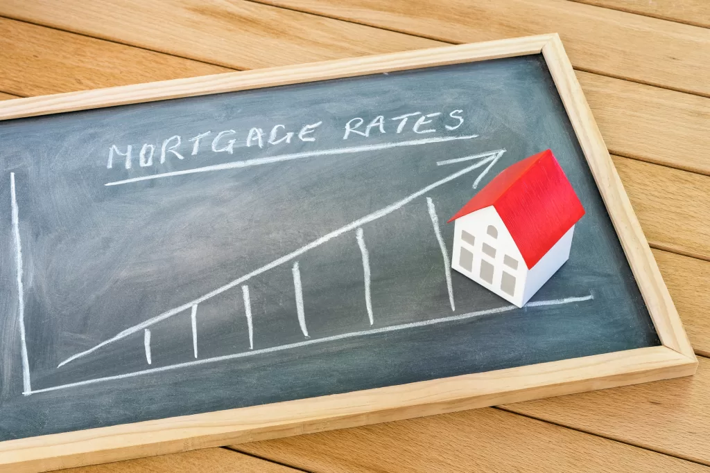 Rising mortgage rate graph on a blackboard lying on a wooden table