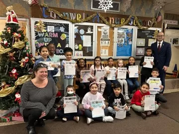 (Photo: Office of NYS Assemblyman Ed Ra) NYS Assemblyman Ed Ra (right) is pictured with Cornwell Avenue School students and their principal, Ms. Deanna Sinito (left).