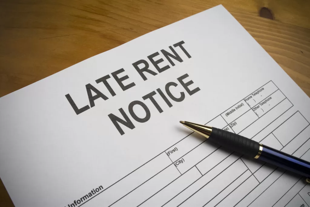 Late rent notice paperwork with pen
