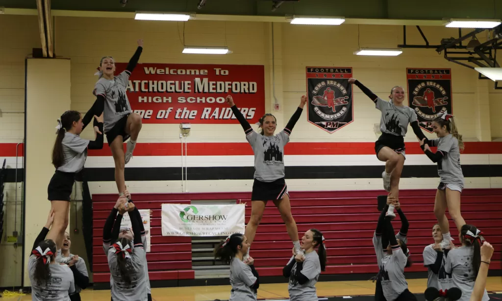 (Photo by Hank Russell) The Patchogue-Medford High School cheerleading squad performs a routine at their sendoff ceremony on February 8.