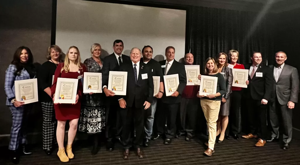 (Photo: Office of Legislator Arnold Drucker) Nassau County Arnold Drucker and Joshua Lafazan present citations to the members of the Woodbury-Syosset Chamber of Commerce as the chamber celebrates its 25th anniversary.