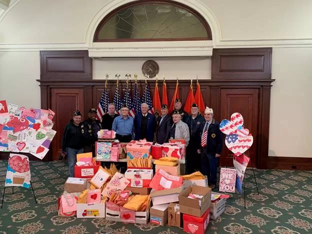 (Photo: Office of William Gaylor) Nassau County William Gaylor, County Executive Bruce Blakeman and Veterans Service Agency Director Ralph Esposito pose with local veterans and valentines created by local school children.