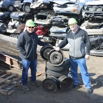 Gershow Manager Jonathan Abrams (left) and Newfield High School Drama Club Set Builder Sean Austin (right) pose with the rims and tires that will be used in the school’s production of “Footloose.”
