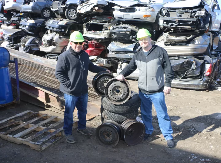 Gershow Manager Jonathan Abrams (left) and Newfield High School Drama Club Set Builder Sean Austin (right) pose with the rims and tires that will be used in the school’s production of “Footloose.”