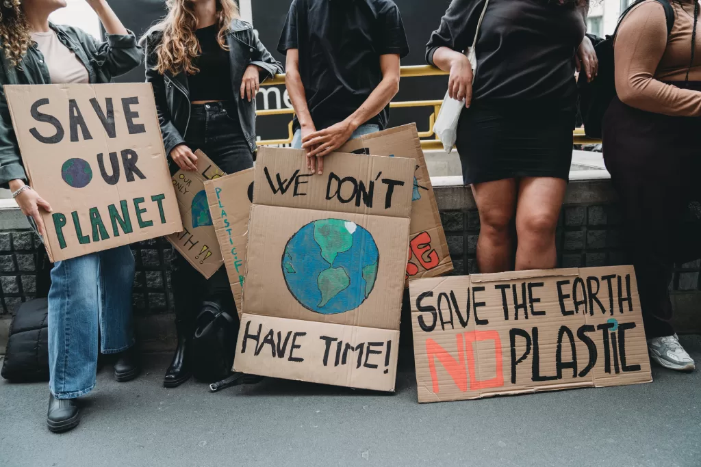 People are holding banner signs while they are going to a demonstration against climate change