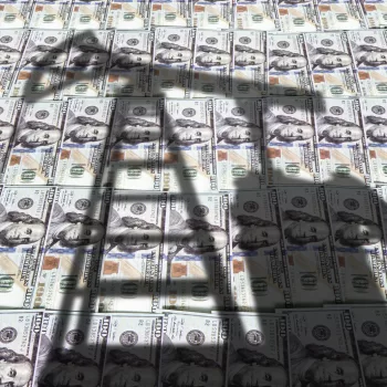 Petroleum, petrodollar crude oil concept : Pump jack on US US dollar notes, depicts the money received or earned from sales after investment in the development of oil industry.