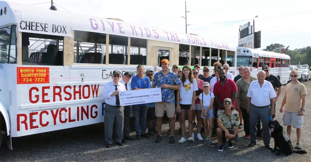 North Fork Sanitation Owner Scott Schelin (center, standing behind check) is joined by members of the Suffolk Masonic District at the demolition derby fundraiser for Give Kids The World Village at Riverhead Raceway on July 15. Gershow Recycling donated $1,050 to the organization. Also pictured with the check (left to right): Stu Smith, Past Master, Distinguished Service Award; John Finley, Right Worshipful and Masonic War Veteran John Finley; Suffolk Masonic District Junior Warden Ezra Fife, and Junior Grand Deacon Al Cortizo of Grand Lodge New York.