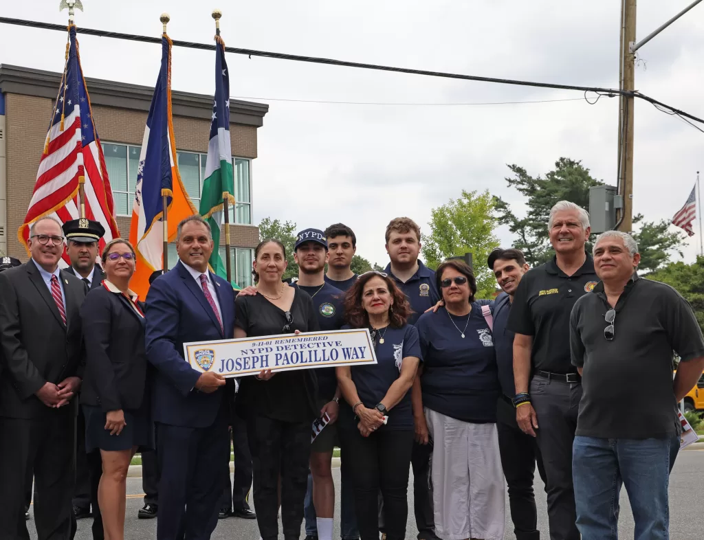(Photo Courtesy of the Town of Oyster Bay) Oyster Bay Town Supervisor Joseph Saladino (fourth from left) is joined by Nassau County Executive Bruce Blakeman (second from right), Town board members,  and members of the NYPD during the ceremonial renaming of Sheppard Street in Glen Head to NYPD Detective Joseph Paolillo Way on August 4.