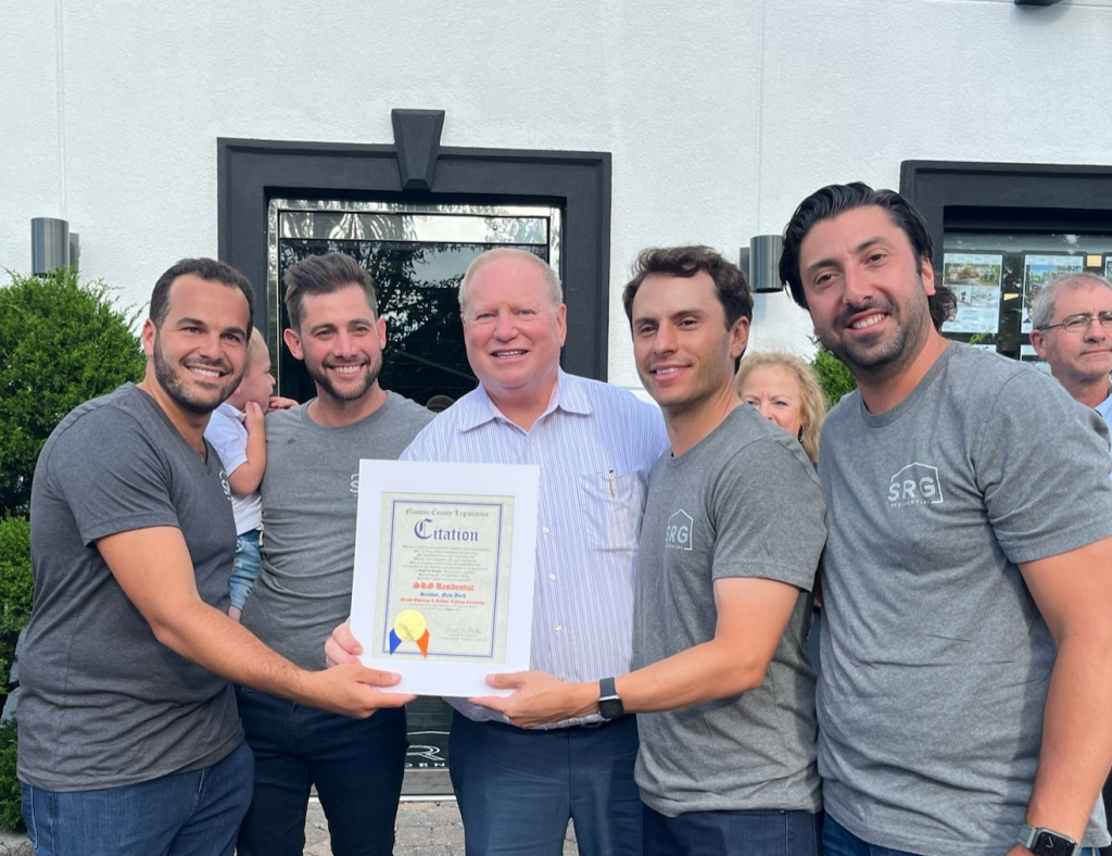 (Photo: Office of Legislator Arnold W. Drucker) Nassau County Legislator Arnold Drucker (center) presented a Nassau County Legislature Citation to SRG Residential Brokerage co-founders Sam Horowitz, David Cohen, Jared Sarney and Stephen Gaon at their firm's grand opening on August 8.