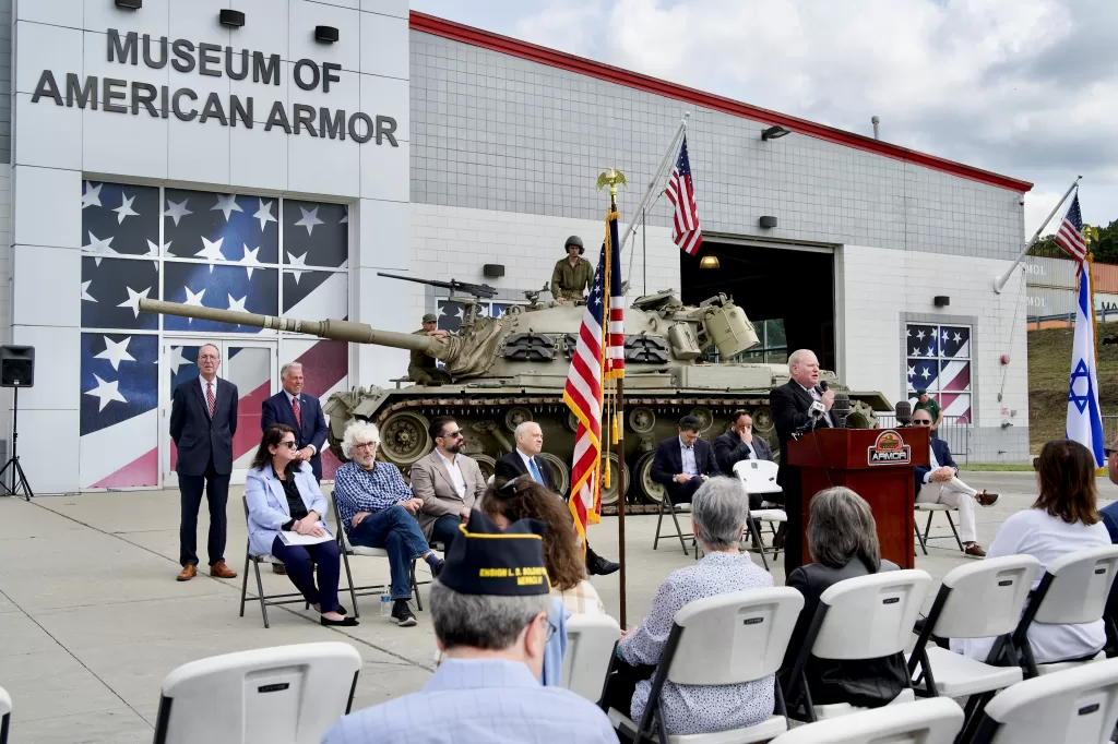 (Photo Courtesy of the Museum of American Armor) Nassau County Legislator Arnold Drucker speaks at a special ceremony commemorating the 50th anniversary of the Yom Kippur War at the Museum of American Armor.