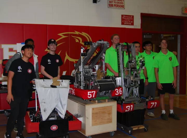 (Photo: FIRSTⓇ Long Island) Patchogue-Medford “Mohawks” (Team #329), Kings Park “Kingsmen” (Team #5736) and Westhampton Beach “HURRICANES” (Team #3171) pose with their winning robots and first-place trophies at the Half Hollow Hills Invitational on October 28.