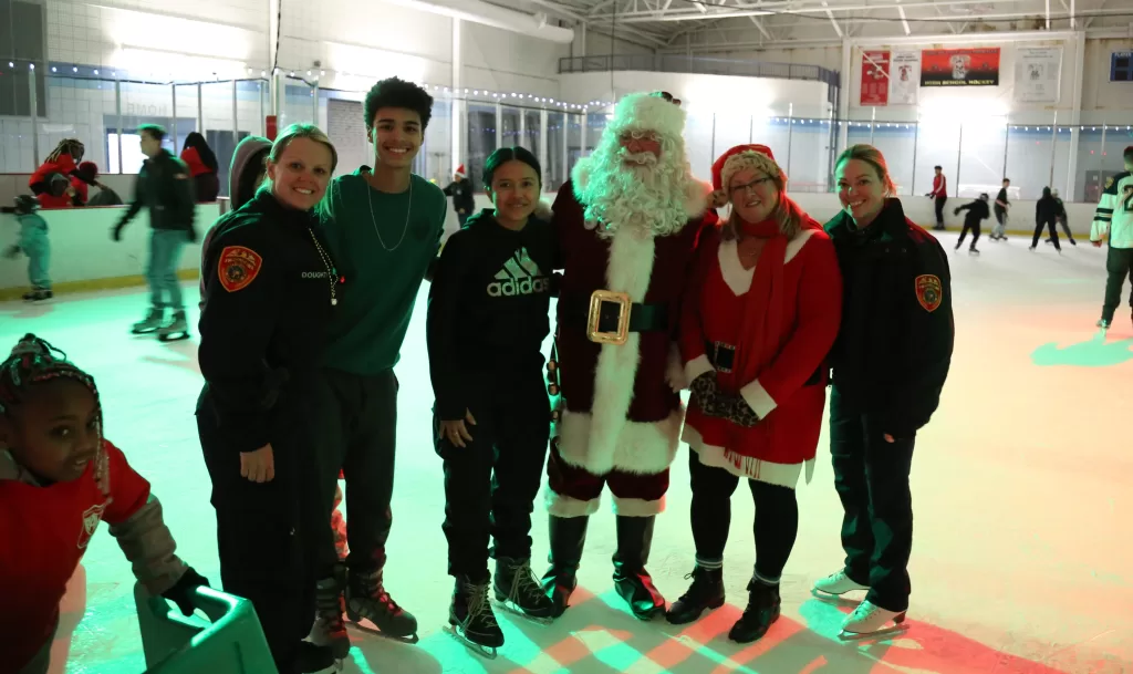 (Photo: SCPD) Members of the Suffolk County Police Department are joined by Santa Claus and local residents at the Skate with a Cop event on December 13.