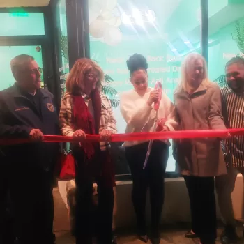 (Photo: Caitlin Crudden) Trinity Village Acupuncture Owner Jade Lominy (center) cuts the ribbon during the grand opening on January 12. Also pictured are Suffolk County Legislator Dominick Thorne (left) and Kim Ziwicki (second from left) from New York State Senator Dean Murray’s office.