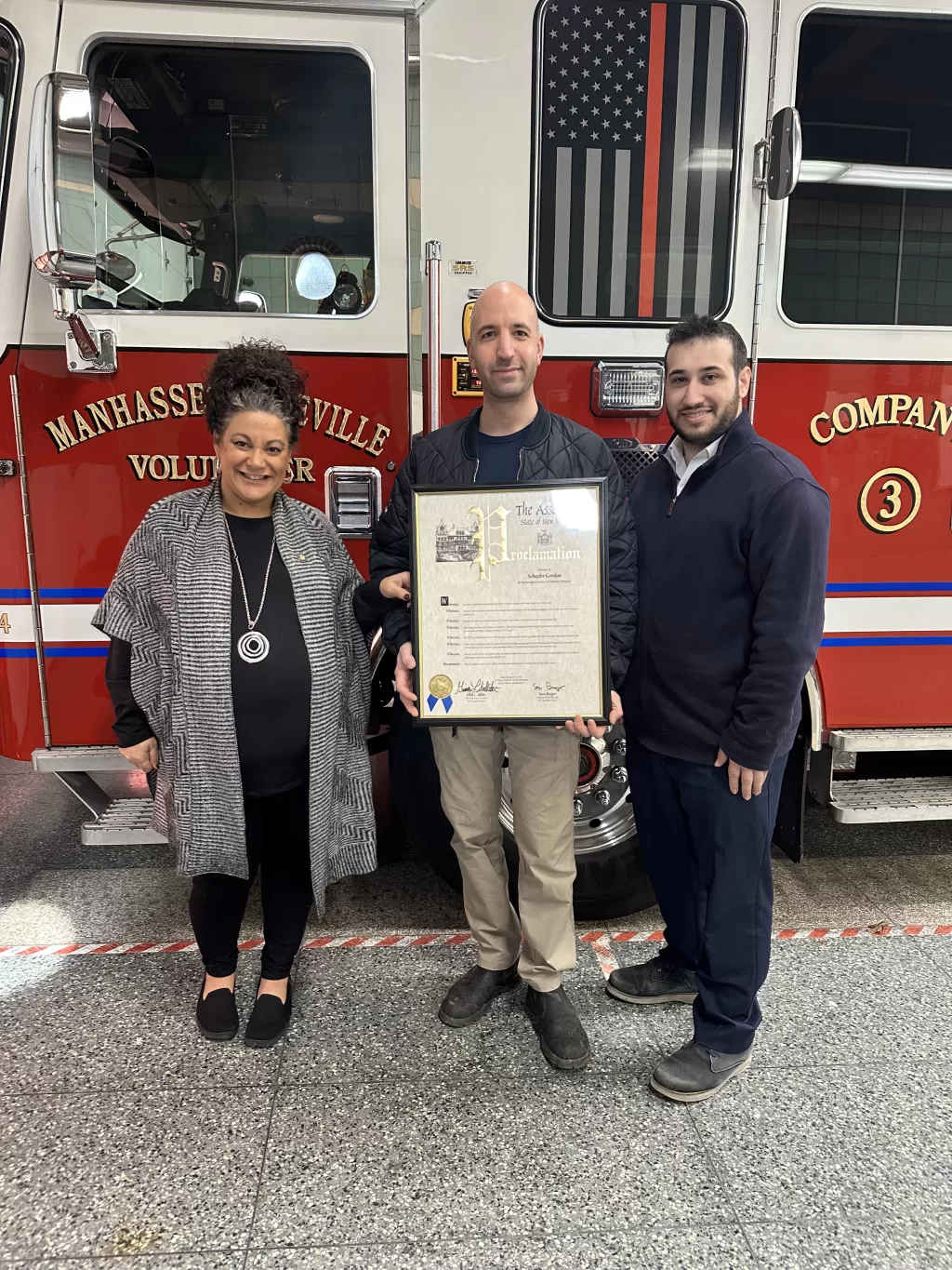 (Photo: Office of NYS Assemblywoman Gina Sillitti) NYS Assemblywoman Gina Sillitti (left) joins Assemblyman Sam Berger (right) to present a proclamation to firefighter Schuyler Gordon (center) for his bravery and selflessness in service to others.