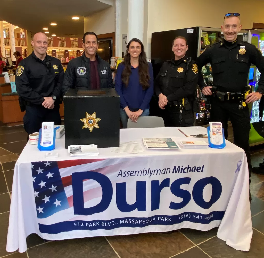 (Photo: Office of NYS Assemblyman Michael Durso) New York State Assemblyman Michael Durso (2nd from left), West Islip Public Library Staffer Michaela Carrillo (center), and members of the Suffolk County Sheriff’s Office take part in the free Shed the Meds event.