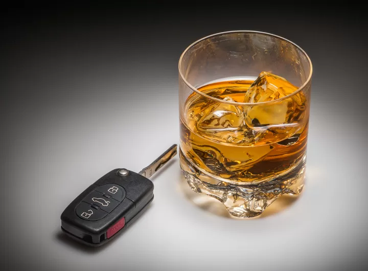 Drinking and driving concept shot