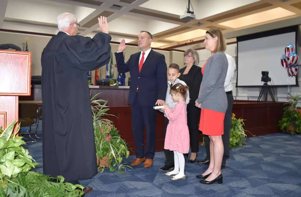 (Photo: Town of Brookhaven) Dan Panico (second from left) is sworn in by the Honorable Timothy P. Mazzei (left) as Brookhaven Town Supervisor at Brookhaven Town Hall on January 8. He is joined by (clockwise, left to right) his in-laws, Darlene and Patrick Scorzelli; his wife Deanna Panico; and his children Brooke and Grant Panico.