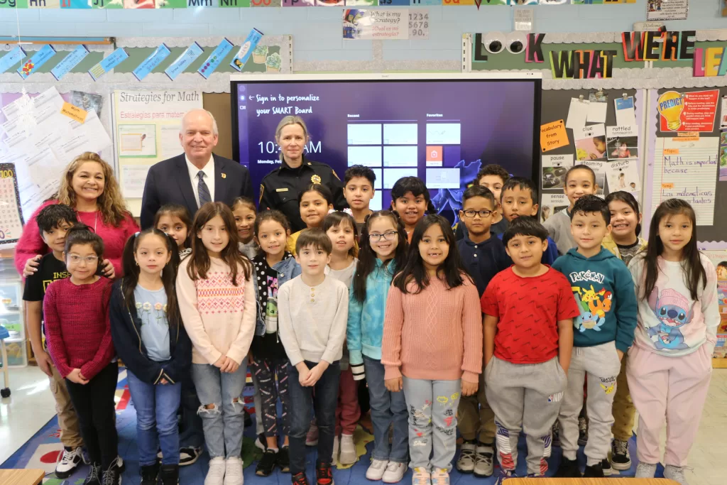 (Photo: Village of Islandia) Islandia Village Mayor Allan M. Dorman and Public Safety Code Enforcement Supervisor Kim Davis are joined by Ms. Maricel La Cruz and students at her second-grade class for the PARP (Pick A Reading Partner) event at Andrew T. Morrow Elementary School on February 5.