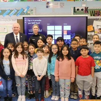 (Photo: Village of Islandia) Islandia Village Mayor Allan M. Dorman and Public Safety Code Enforcement Supervisor Kim Davis are joined by Ms. Maricel La Cruz and students at her second-grade class for the PARP (Pick A Reading Partner) event at Andrew T. Morrow Elementary School on February 5.