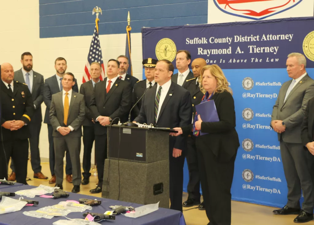 (Photo: Hank Russell) Suffolk County District Attorney Ray Tierney is joined at the podium by Nassau County District Attorney Anne Donnelly at a press conference at the Suffolk County Police Academy in Brentwood on February 15. Also pictured behind Tierney are Suffolk County Acting Police Commissioner Robert Waring (left) and Suffolk County Sheriff Errol Toulon (right).
