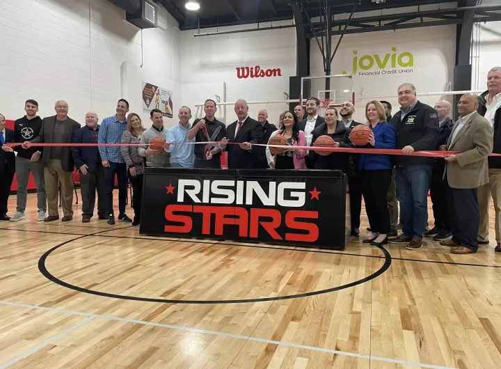 (Photo: Office of Legislator Debra Mulé) Nassau County Legislator Debra Mulé (third from right, holding basketball) joins in the ribbon cutting for the grand opening of Rising Stars on March 5.