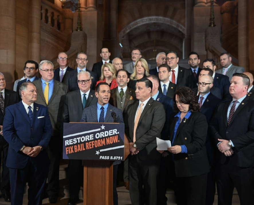 (Photo: NYS Assembly) NYS Assemblyman Michael Durso (standing behind podium) attends a press conference with GOP Assembly members and state Senators on March 12 calling for changes to bail reform after a suspect in the human remains case was released.