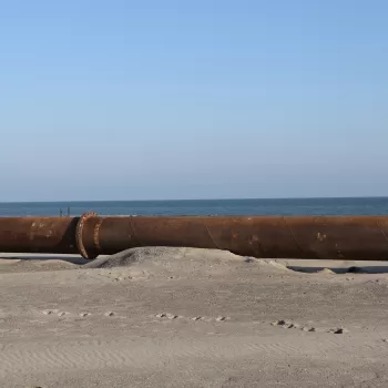 a steel pipe on the beach for conveying sand