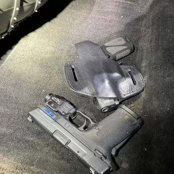 (Photo Courtesy of the Nassau DA's Office) These two guns were recovered from Kim Lilly's vehicle. Lilly was arraigned on a 59-count indictment of trafficking illegal firearms into Nassau County.
