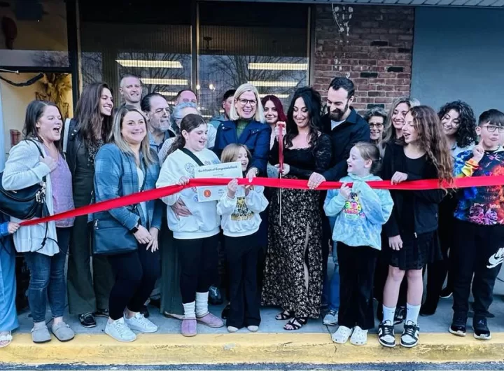 (Photo: Town of Brookhaven) Brookhaven Town Councilwoman Jane Bonner joins Hairology Owner Leah Barnetas (center right, holding scissors) in the ribbon cutting of the new salon on April 5.