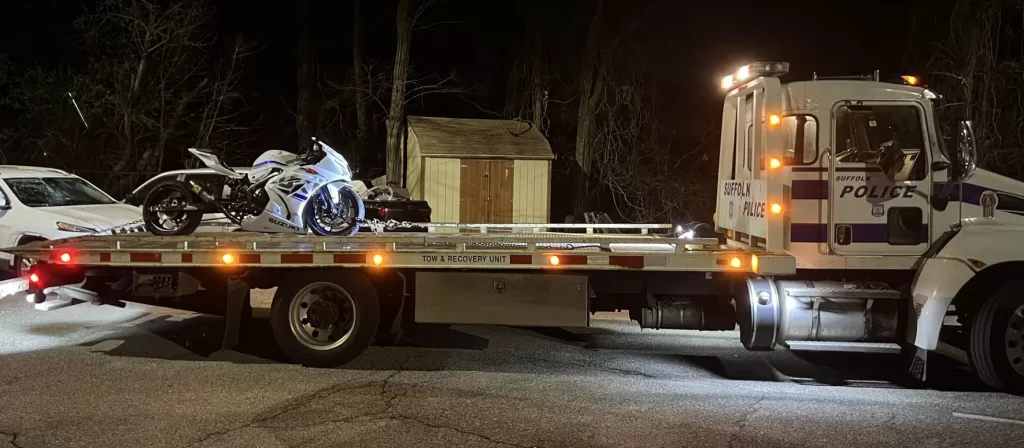 (Photo Courtesy of SCPD) Suffolk County police take away a motorcycle after Antonino Mangogna was arrested for drag racing in West Babylon.