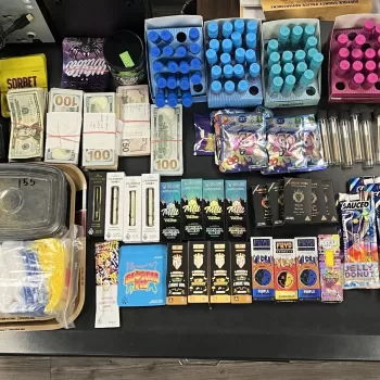 (Photo Courtesy of SCPD) Police display the products and cash seized from Rollie’s Smoke Shop IV in Huntington Station.