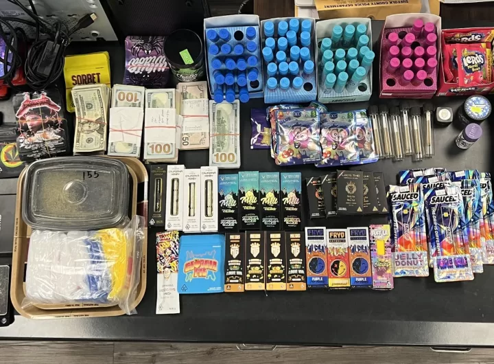 (Photo Courtesy of SCPD) Police display the products and cash seized from Rollie’s Smoke Shop IV in Huntington Station.