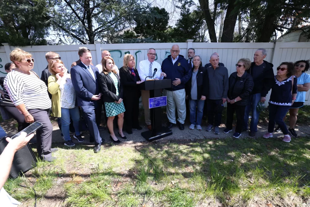 (Photo: Town of Hempstead) Hempstead Town Supervisor Don Clavin (standing behind podium) held a press conference on April 15 to denounce a bias incident that occurred in East Meadow earlier in the day.