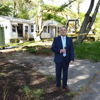 (Photo: Town of Brookhaven) Brookhaven Town Supervisor Dan Panico poses in front of a "zombie home" in Medford.