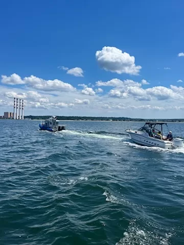 (Photo Courtesy of SCPD) The Suffolk County Marine Bureau tows a boat back to the Soundview boat ramp in Northport.