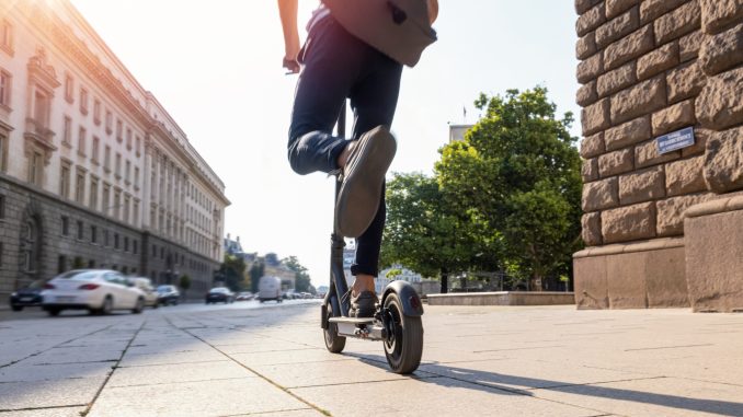 Man riding electric scooter in the morning