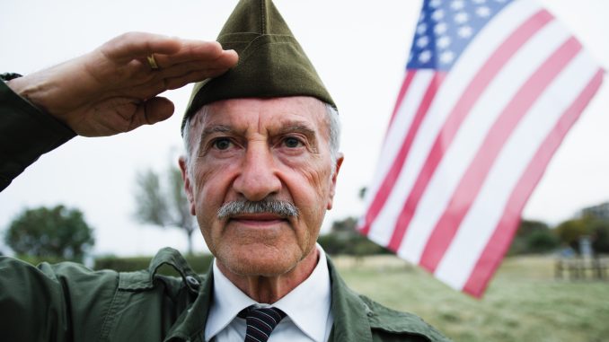 Veteran Salutes The American Flag On Memorial Day In The Cemetery Outdoor