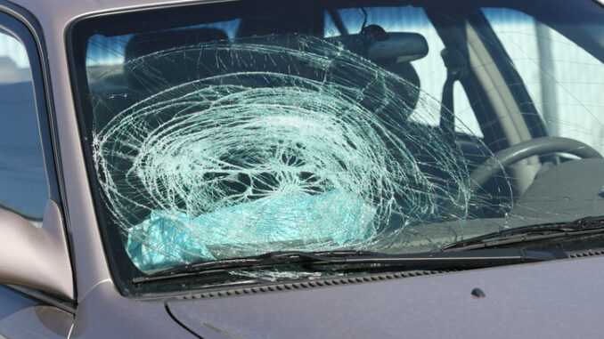 Broken windshield on a grey car