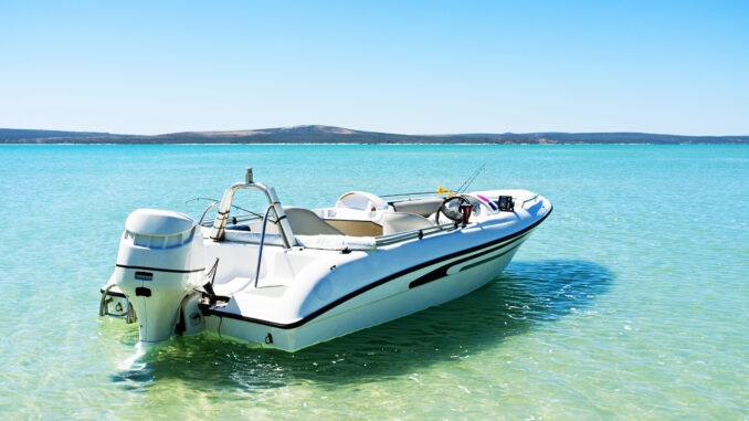 Speed boat moored in the shallows of turquoise lagoon